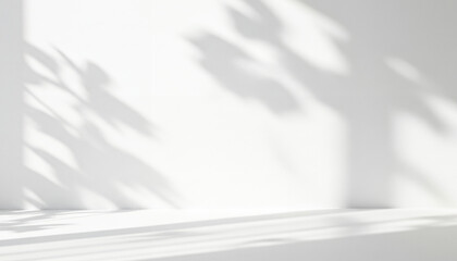 Obraz premium White wall with plant shadows and sunlight creating abstract patterns, blending bright natural tones, soft silhouettes, and the elegance of organic flow.