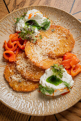 Golden pancakes topped with fresh herbs and creamy accompaniments create a culinary delight