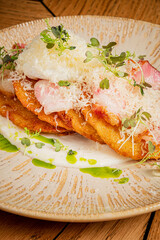 Crispy layers with rich toppings and fresh herbs make a tantalizing dish for food lovers
