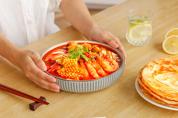 Spicy Seafood Hot Pot with Shrimp and Corn Served on Wooden Table