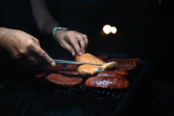 Grilling Sucuk Sausage and Bread on Barbecue at Night