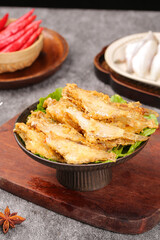 Crispy Fried Fish Fillets in Traditional Ceramic Bowl with Asian Cuisine Side Dishes