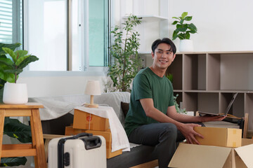 Home Organization. Young couple unpacking boxes and arranging their new living space.