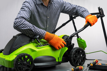  A man assembling a new, unboxed lawn mower.