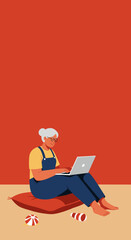 Elderly woman with glasses sitting on a cushion, actively using a laptop for communication or learning in a relaxed home setting. Modern senior embracing technology.