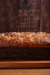 Salvadoran yolk bread with sesame seeds, on a wooden tray