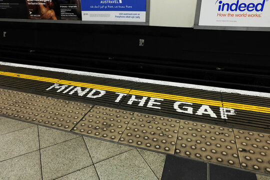 Mind the gap sign painted on the edge of the subway platform in London