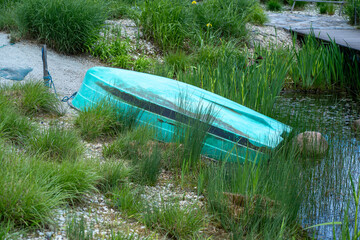 Upside Down Green Boat by Grassy Lakeshore