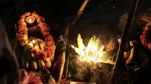 festive chhath puja ritual with daali of fruits and lit diya at riverside