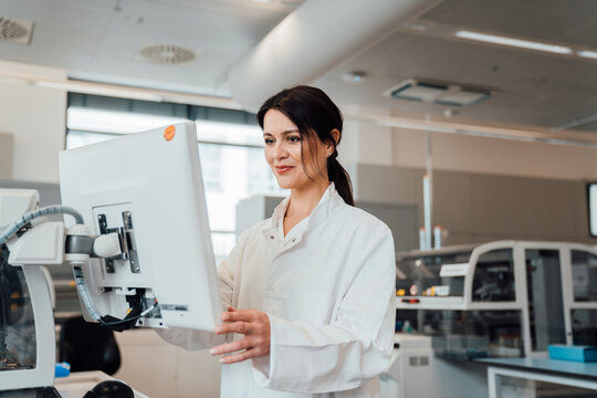 Scientist analysing data on computer in modern medical laboratory