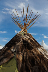 A Captivating Traditional Teepee Structure Set Beneath a Vast, Bright Blue Sky Above