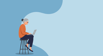 Senior woman in glasses diligently using a laptop while sitting on a stool, embodying digital literacy, online connection, and an active modern lifestyle.