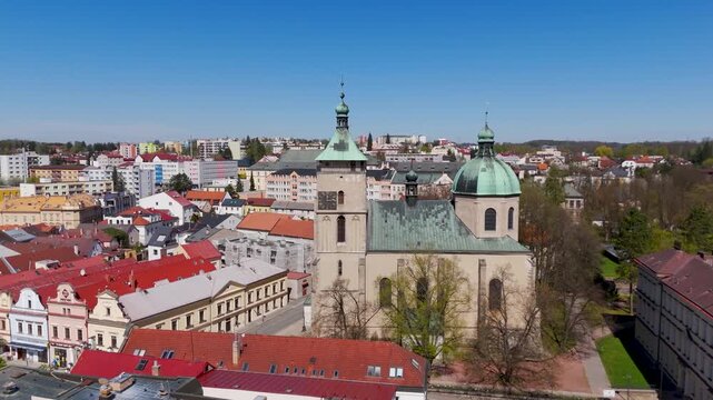 Aerial drone view rising over the historic Old Town Hall and vibrant houses of Havlickuv Brod, Vysocina, Czech Republic.