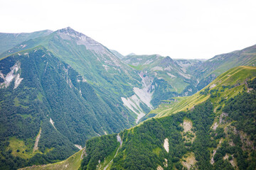 A breathtaking view of lush green mountains and deep valleys, showcasing untouched natural beauty. Perfect for hiking, nature lovers, and outdoor adventure inspiration in Kezbegi, Georgia