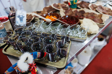 A traditional food display featuring beverages alongside dried meat offerings on show