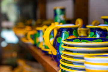 Typical souvenirs in a shop in historic village San Gimignano, Tuscany, Italy. Detail of a local shop in the streets. Traditional souvenirs of ceramics. Europe tourism or vacation travel concept.