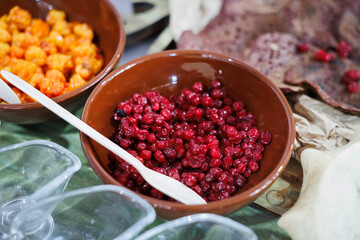 A collection of vibrant berries and delicious snacks beautifully arranged in rustic bowls