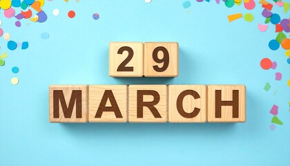 Wooden Blocks with Date 29 March. Calendar for birthday or anniversary on solid colored background with confetti