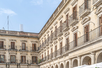 Fototapeta premium Historic Spain Square Neoclassical Architecture in Vitoria Gasteiz Basque Country Spain. Portico arches, balconies, stone facades, town hall square