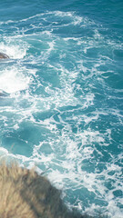 Vertical Ocean Wave Crashing on Rocky Cliff – Japanese Style Blue Tone Seascape Photo