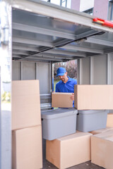 Close-up courier service employee unloading goods from a van for delivery to customers. concept logistics, delivery services