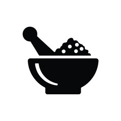 Black silhouette of a mortar and pestle with ground ingredients