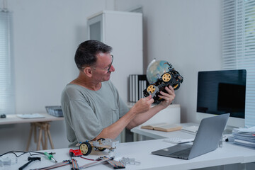 Robotics engineer assembling a toy car in a bright, modern office, focusing on the project with a laptop and soldering iron, showcasing skills in electronics and innovation