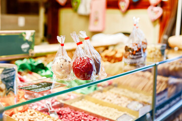 Traditional christmas market in the historic center of Nuremberg, Germany. Decorated with garland and lights sale stalls with sweets, mulled wine and Xmas decoration and German gifts.