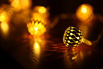 yellow garland in the form of small lanterns, creates pleasant lighting and a beautiful pattern on...