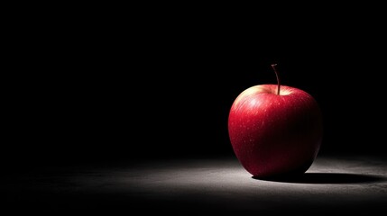 Red apple in dramatic lighting