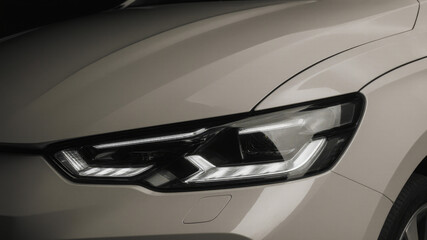 Fototapeta premium Close-up of car headlight and hood on white