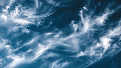 Wispy clouds against a deep blue sky