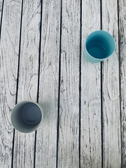 Colorful glasses in the foreground on an old rustic wooden table