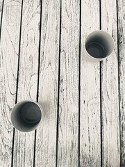 Colorful glasses in the foreground on an old rustic wooden table