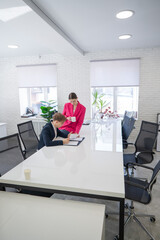 Caucasian woman giving instructions to subordinate. 