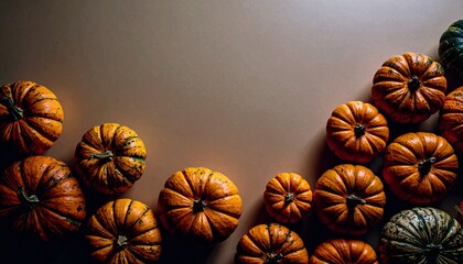 pumpkins of different sizes on a dark background with space for text