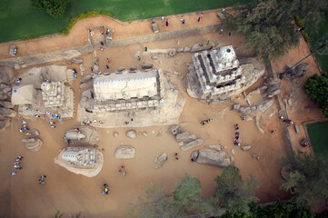Mahabalipuram, India - 17 September 2006: Aerial view of the Pancha Rathas, ancient monolithic rock-cut temples, stand as silent sentinels against the sandy earth.