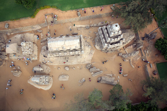 Mahabalipuram, India - 17 September 2006: Aerial view of the Pancha Rathas, ancient monolithic rock-cut temples, stand as silent sentinels against the sandy earth.