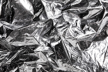 Abstract metallic foil background with crumpled and reflective surface