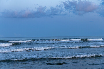 Waves wash the sandy shore of the Mediterranean Sea. Seascape. Italy