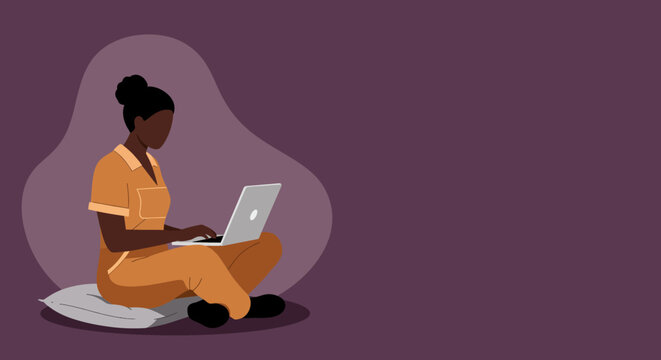 Young Black woman working on a laptop from home, sitting comfortably on a cushion. Represents remote work, flexible lifestyle, or online learning and productivity.