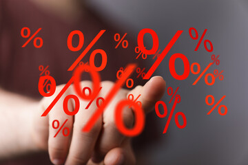 Hand interacting with percentage symbols.  Concept for finance, banking, discount, interest rates, investments, sales, and more.