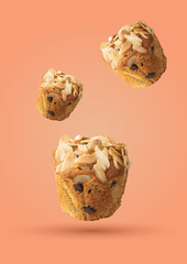 Three Almond Muffin Bakes of different sizes arranged on a pink background.