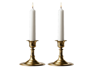 Two gold candle holders with white candles