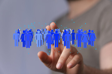 Image depicts a hand interacting with a digital network of diverse people, symbolizing global community, networking, and connection.