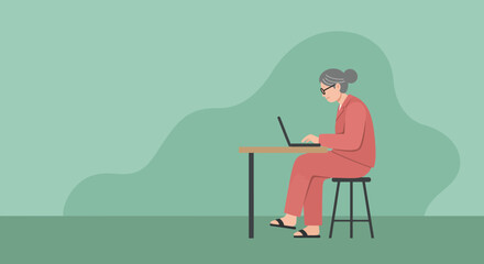 An elderly woman with glasses intently works on her laptop at a desk, showcasing senior digital literacy and remote productivity. Ideal for technology, business, or lifestyle themes.