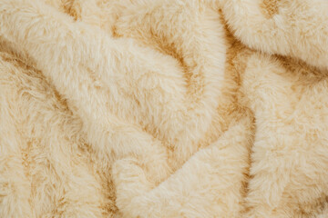 Soft beige fur texture for cozy winter fashion or interior design concepts