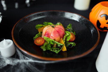 Ghoulish Gourmand: A visually appealing autumn dish, with a striking presentation, and captivating textures. Set on a matte black dish, and illuminated by soft candle light.