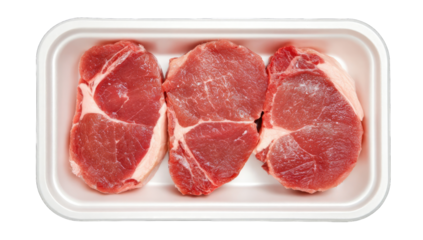 Three raw pork chops in a white plastic tray
