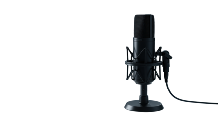 Three modern black studio condenser microphones, one sharp, two blurred, on sleek white desk with blurred headphones and laptop, professional digital audio concept